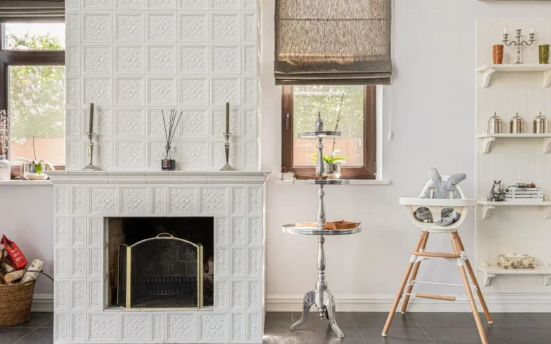 A chic interior featuring a white ornate fireplace, stylish furniture, and modern decor elements.