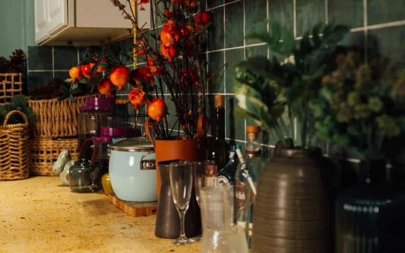 Warm kitchen counter adorned with plants and autumn-themed decor.