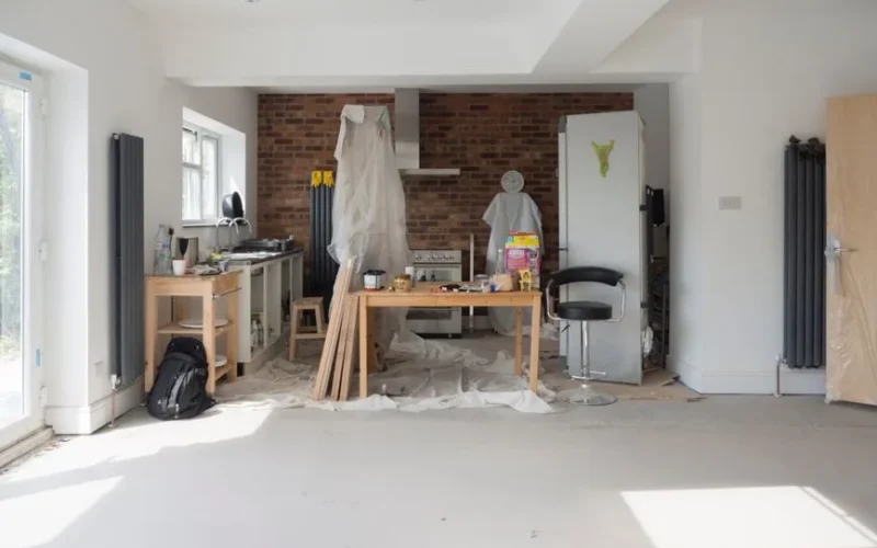 Bright kitchen extension showing renovation work with tools and materials.