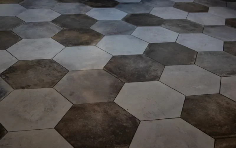 Elegant hexagonal floor tiles create a striking marble pattern, perfect for modern interiors.
