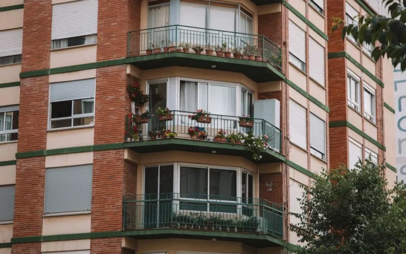 A beautiful urban building in Valencia with flower-adorned balconies and greenery, perfect for architectural themes.